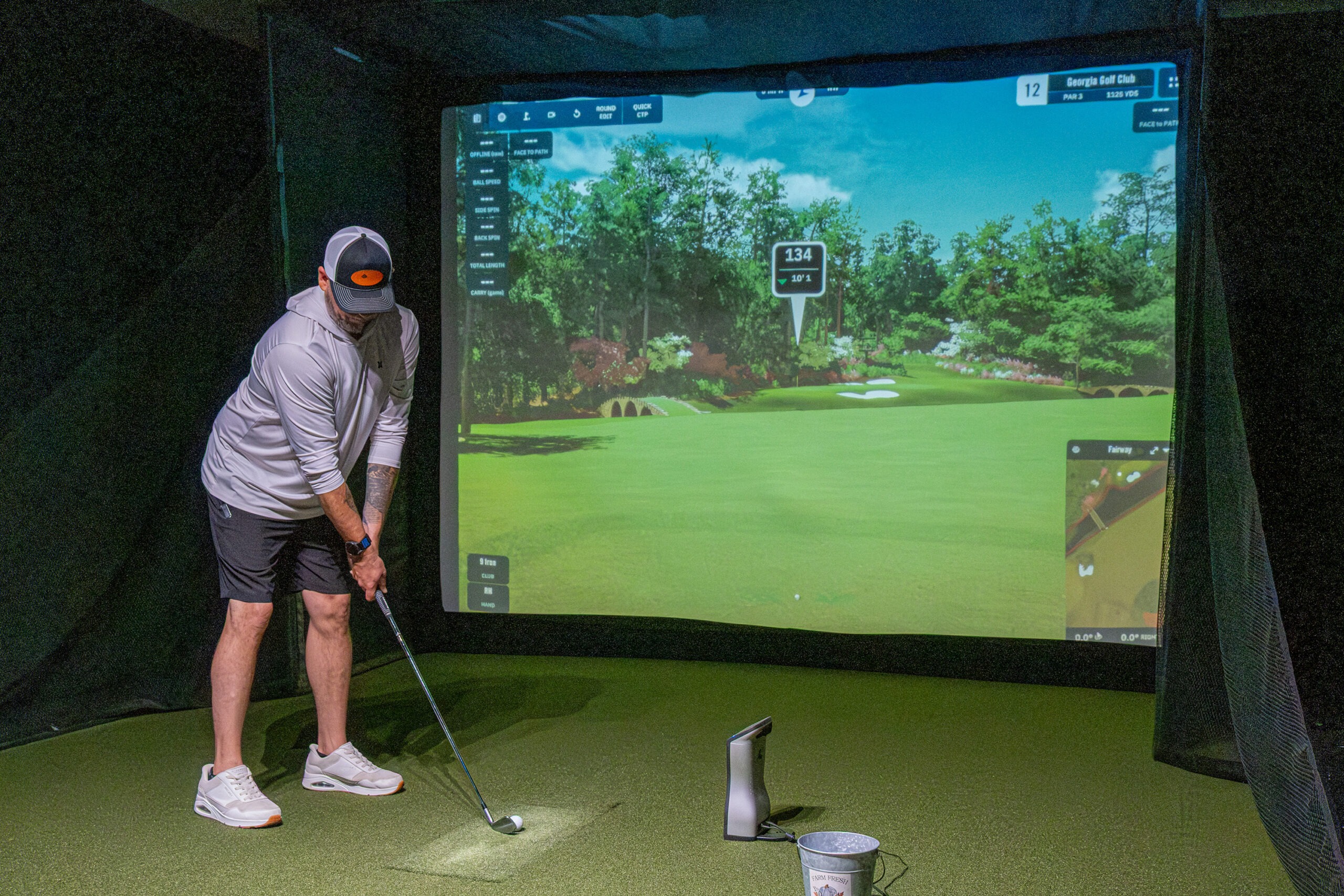Golfer taking a swing at the simulator